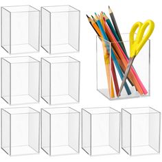 six clear cubes with pencils and scissors in them, all lined up next to each other