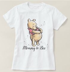 a t - shirt with an image of winnie the pooh holding a pink ribbon