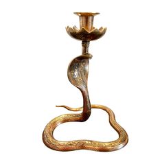 an ornate candle holder with a snake on it