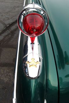 the rear end of a green classic car