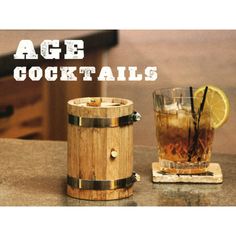 an old fashioned wooden beverage dispenser next to a glass filled with ice