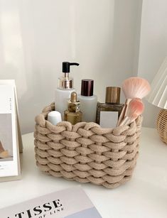 a basket that is on top of a table next to a magazine and other items