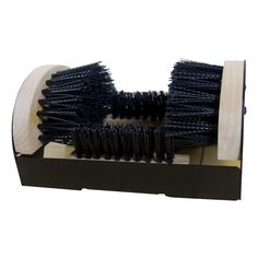 a black brush sitting on top of a wooden box