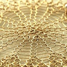 a close up view of a gold plate that has been made to look like a spider web