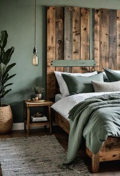 a bedroom with green walls and wooden headboard