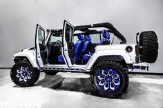 a white and blue jeep with its doors open