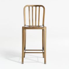 a golden metal bar stool against a white background with the seat up and back down