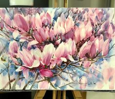 a painting of pink flowers on a easel