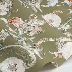 the wallpaper is green with white flowers and animals on it's side,