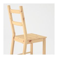 a wooden chair sitting on top of a white floor