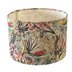 a lamp shade with an image of flowers on it's side and leaves in the middle