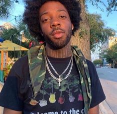 a man with an afro wearing a t - shirt that says welcome to the c