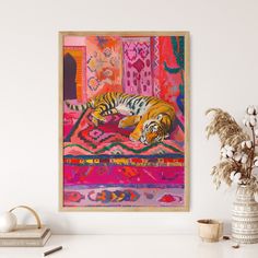 a tiger laying on top of a colorful rug next to a vase with flowers in it