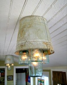 a chandelier hanging from the ceiling in a room with white paint and light bulbs