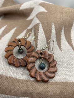 Leather Concho earrings. Made in Wyoming. Quality leather and stone used. Hypoallergenic earring wires. Leather Dangle Earrings With Ear Wire, Hand Tooled Adjustable Jewelry For Everyday, Bohemian Leather Drop Earrings, Artisan Leather Nickel-free Earrings, Elegant Hand-tooled Brown Jewelry, Elegant Hand Tooled Brown Jewelry, Bohemian Leather Dangle Earrings, Rustic Leather Dangle Jewelry, Bohemian Leather Jewelry For Everyday