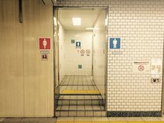 an open door leading to a bathroom stall