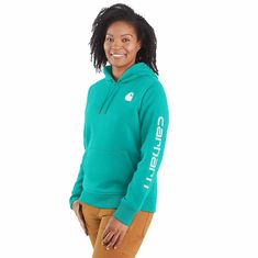 Cold winter mornings are a lot more comfortable with this women's cozy hoodie. Made of heavyweight fleece, the sweatshirt is brushed on the inside for extra softness. It has a relaxed fit that allows for easy layering, and it's finished with a Carhartt logo down the sleeve. Features10.5-ounce, 73% cotton / 27% polyesterThree-piece hood with drawcordRib-knit cuffs and waist help keep out the coldFront pouch pocketCarhartt signature logo printed on sleeve; Carhartt 'C' graphic on frontModel in Bla Womens Carhartt Hoodie, Womens Carhartt, Carhartt Logo, Carhartt Hoodie, Carhartt Womens, Safety Clothing, Carhartt Women, Women Hoodies Sweatshirts, Workout Hoodie