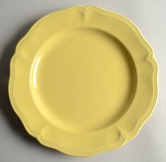 a yellow plate sitting on top of a white table