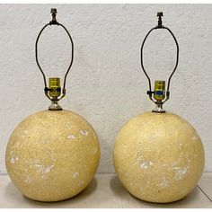 two yellow vases sitting on top of each other