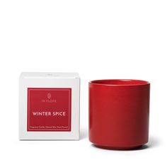 a red coffee mug sitting next to a box on a white background with the words winter spice in it