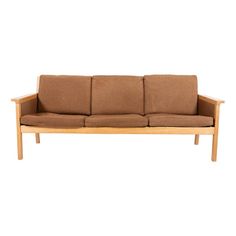 a wooden couch with brown cushions on it's back and arm rests against a white background