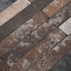 a close up view of a brick floor with white and brown tiles on it's sides