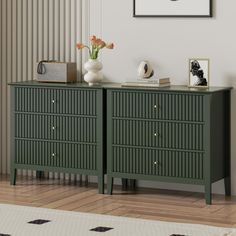 a green dresser with drawers and pictures on it in a room that has striped walls