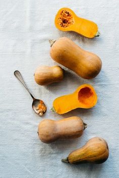 squash on a table with spoons next to it