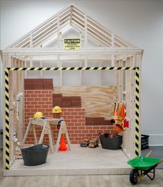 an unfinished room with construction equipment on the floor and around it is a brick wall