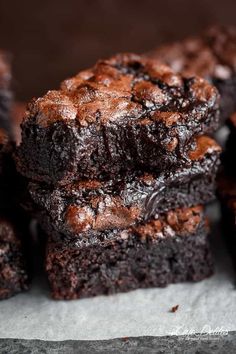 chocolate brownies stacked on top of each other with one bite taken out of it