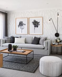 a living room filled with furniture and pictures on the wall above it's coffee table