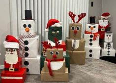 several cardboard boxes with christmas decorations and santa hats on them, all decorated like snowmen