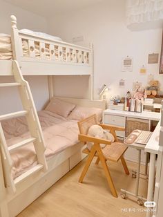 a bunk bed sitting next to a desk with a chair on it in a room