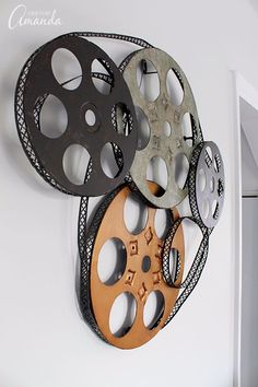 an assortment of film reels hanging on the wall