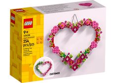 a heart shaped decoration made out of legos with flowers on the front and bottom