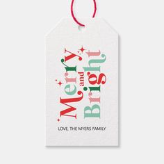 a christmas gift tag with the words merry and bright on it, hanging from a red string