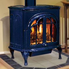 a blue stove sitting on top of a tiled floor