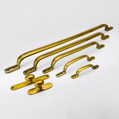 five brass handles and four pulls on a white background