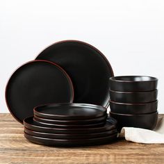 black and brown dinnerware set on wooden table