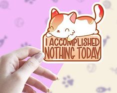 a hand holding up a sticker that says i accomplished nothing today