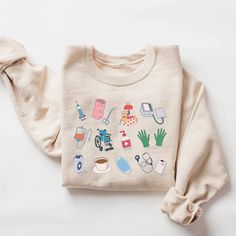 a white sweater with various items on it