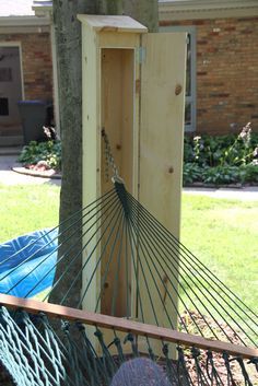 a hammock hanging from a tree next to a building