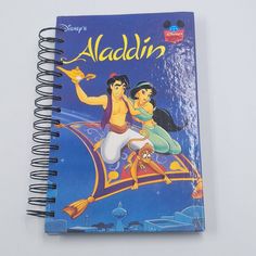 a notebook with the title disney's alaadd on it and an image of two