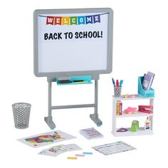 a whiteboard and desk with toys on it for children to play in the room