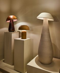 three different types of lamps on display in a room