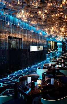 an empty restaurant with chandeliers hanging from the ceiling