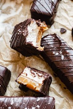 chocolate covered pieces of food sitting on top of paper next to each other and broken in half