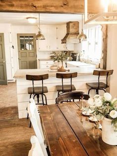 a wooden table sitting in the middle of a kitchen