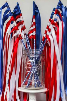 red, white and blue flags in a vase with text overlay reading independence day flag wands