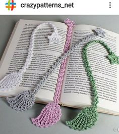 an open book with crocheted necklaces on it